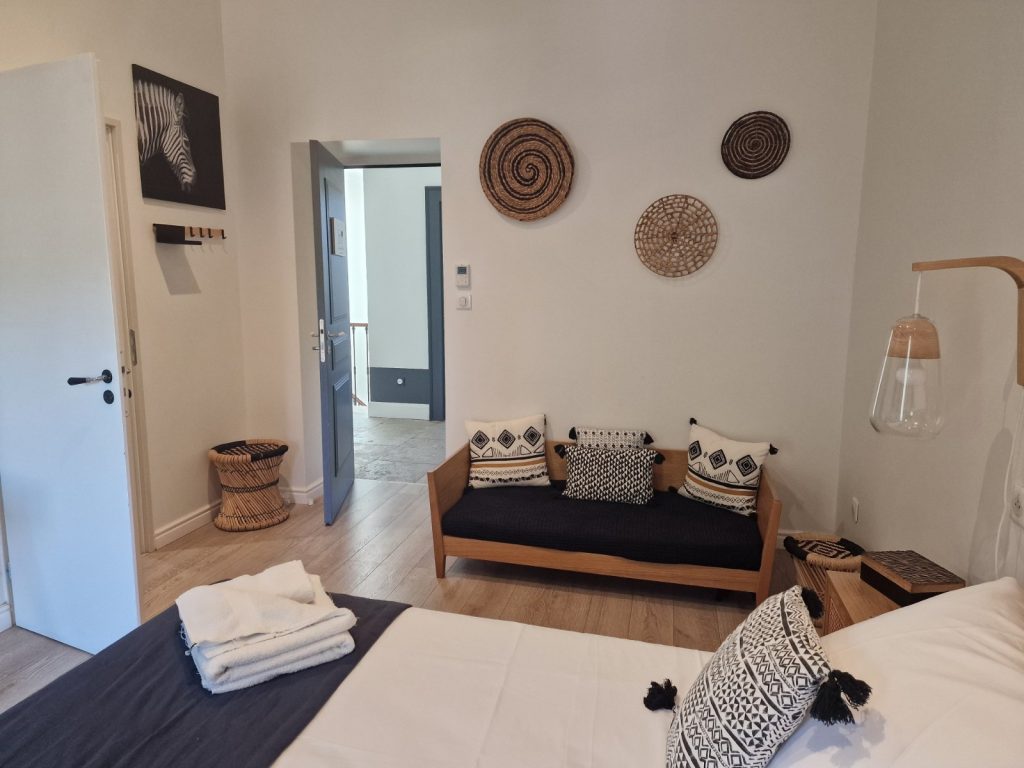 Tidy living room with a bed, sofa and wooden floor