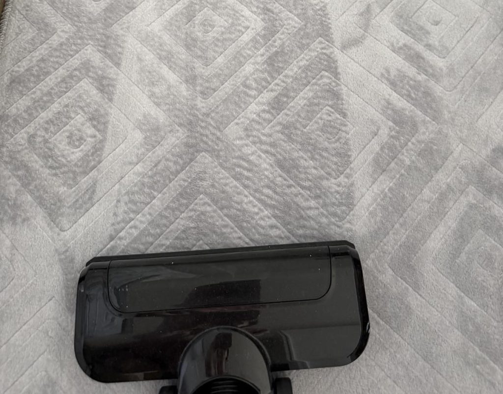 Cleaning the surface of a mattress with a vacuum cleaner attachment